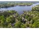 Scenic aerial view of lakefront property with mature trees and a charming home at 955 Sagamore Dr, Louisburg, NC 27549