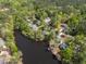 Aerial view of a lakeside community with lush trees, manicured lawns, and tranquil waters for a serene living environment at 955 Sagamore Dr, Louisburg, NC 27549