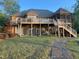 Spacious backyard featuring a multi-level deck and a well-maintained lawn leading to the home at 955 Sagamore Dr, Louisburg, NC 27549