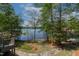 Lush backyard with beautiful stone walkway and mature trees that provide lake views at 955 Sagamore Dr, Louisburg, NC 27549