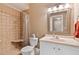 Cozy bathroom featuring a tiled shower, toilet, and vanity with a framed mirror at 955 Sagamore Dr, Louisburg, NC 27549