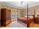 Bedroom featuring a four-poster bed, French doors, and wood flooring at 955 Sagamore Dr, Louisburg, NC 27549