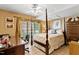 Elegant bedroom featuring a four-poster bed, desk, and bright windows with draperies at 955 Sagamore Dr, Louisburg, NC 27549