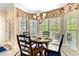 Cozy breakfast nook surrounded by windows, offering ample natural light and a view of the outdoors at 955 Sagamore Dr, Louisburg, NC 27549