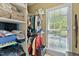 Organized closet with shelves, hanging rods, and a window providing natural light at 955 Sagamore Dr, Louisburg, NC 27549
