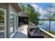 Entertain on this covered deck, featuring a grill and great lake views at 955 Sagamore Dr, Louisburg, NC 27549