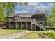 Large brick home with multi-level deck and screened porch in a green setting at 955 Sagamore Dr, Louisburg, NC 27549