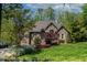 Inviting brick home featuring well-manicured lawn and beautiful garden with lake views at 955 Sagamore Dr, Louisburg, NC 27549