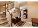 Inviting foyer with a staircase, decorative wall hangings, and a glimpse of the bar area at 955 Sagamore Dr, Louisburg, NC 27549