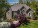 Charming brick home featuring a landscaped front yard, complemented by mature trees and a welcoming walkway to the front door at 955 Sagamore Dr, Louisburg, NC 27549