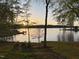Beautiful lakeside scene with a dock visible, creating a serene and picturesque waterfront property at 955 Sagamore Dr, Louisburg, NC 27549