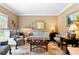 Cozy living room featuring decorative furniture, crown molding, and natural light at 955 Sagamore Dr, Louisburg, NC 27549