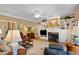 Bright living room with fireplace, custom built-ins, and a ceiling fan at 955 Sagamore Dr, Louisburg, NC 27549