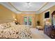 Bright main bedroom boasts neutral walls, plush carpet, and French doors with exterior views at 955 Sagamore Dr, Louisburg, NC 27549