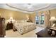 Spacious main bedroom with a tray ceiling, neutral decor, and French doors leading to a balcony at 955 Sagamore Dr, Louisburg, NC 27549