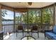 Lake views are enjoyed on this lovely screened in porch with comfortable seating at 955 Sagamore Dr, Louisburg, NC 27549
