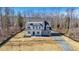 New construction home with stone accents and covered entry surrounded by wooded acreage at 0006 Tallulah Loop Lane, Cedar Grove, NC 27231