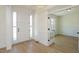 Welcoming foyer with light wood floors, leading to an office space with glass paneled doors at 0006 Tallulah Loop Lane, Cedar Grove, NC 27231