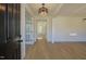 Spacious foyer with light wood floors and wainscoting, leading to various rooms at 0006 Tallulah Loop Lane, Cedar Grove, NC 27231