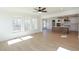 Sun-filled living room features large windows and light wood floors, adjacent to open kitchen at 0006 Tallulah Loop Lane, Cedar Grove, NC 27231
