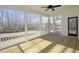 Relaxing screened porch with a ceiling fan and wooden floors, offering a serene outdoor living space at 0006 Tallulah Loop Lane, Cedar Grove, NC 27231