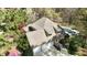 Aerial view of the house featuring an attached garage, long driveway, and backyard swimming pool at 10001 Sandcreek Ct, Chapel Hill, NC 27517
