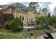 Beautiful backyard with a spacious deck, mature landscaping, and stone patio at 10001 Sandcreek Ct, Chapel Hill, NC 27517
