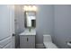 Powder room with modern vanity, designer mirror, and contemporary fixtures at 10001 Sandcreek Ct, Chapel Hill, NC 27517