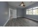 Bedroom with gray flooring, a ceiling fan, a window, and neutral paint at 10001 Sandcreek Ct, Chapel Hill, NC 27517