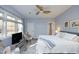 Bright main bedroom with large windows and a ceiling fan at 10001 Sandcreek Ct, Chapel Hill, NC 27517