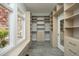 Bright walk-in closet with natural light and extensive custom shelving and cabinetry at 10001 Sandcreek Ct, Chapel Hill, NC 27517