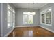 Bright dining room with hardwood floors, large windows, and modern globe pendant lighting at 10001 Sandcreek Ct, Chapel Hill, NC 27517