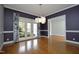 Formal dining room with hardwood floors, modern lighting fixture and french doors at 10001 Sandcreek Ct, Chapel Hill, NC 27517