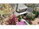 Aerial view of a charming home with a well-manicured lawn and mature trees at 10001 Sandcreek Ct, Chapel Hill, NC 27517