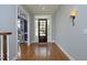 Elegant foyer with hardwood floors, a decorative light fixture, and an inviting view into the adjacent living area at 10001 Sandcreek Ct, Chapel Hill, NC 27517