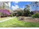 Charming two-story home with a walkway leading to the front door, enhanced by mature landscaping at 10001 Sandcreek Ct, Chapel Hill, NC 27517