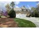 View of home featuring an attached garage, long driveway, and well-maintained landscaping at 10001 Sandcreek Ct, Chapel Hill, NC 27517