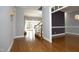 View of hallway into Gathering room and dining room, hardwood floors and staircase at 10001 Sandcreek Ct, Chapel Hill, NC 27517