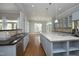 Bright kitchen features a breakfast bar, granite countertops, stainless steel appliances and custom cabinets at 10001 Sandcreek Ct, Chapel Hill, NC 27517