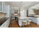 Open kitchen showcases stainless steel appliances, granite counters, and a large island with seating at 10001 Sandcreek Ct, Chapel Hill, NC 27517
