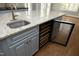 Kitchen island featuring a sink, granite countertop, custom cabinets and wine fridge at 10001 Sandcreek Ct, Chapel Hill, NC 27517