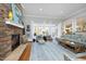 Warm and inviting living room features a stone fireplace, french doors, hardwood floors, and stylish decor for cozy gatherings at 10001 Sandcreek Ct, Chapel Hill, NC 27517