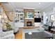 Comfortable living room with hardwood floors, a stone fireplace, and built-in shelves create a welcoming space for relaxation at 10001 Sandcreek Ct, Chapel Hill, NC 27517