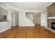 Bright living room with hardwood floors, a stone fireplace, and a staircase provides a spacious and welcoming atmosphere at 10001 Sandcreek Ct, Chapel Hill, NC 27517