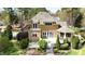 View of home's backyard with a multi-level patio, gazebo and landscaped yard at 10001 Sandcreek Ct, Chapel Hill, NC 27517