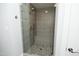 Elegant tiled shower with a glass enclosure and rainfall showerhead at 10001 Sandcreek Ct, Chapel Hill, NC 27517