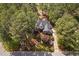 An aerial view of a luxurious home surrounded by lush, mature trees with a large manicured lawn at 101 Preston Arbor Ln, Cary, NC 27513