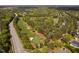 An aerial view captures the stunning golf course and a home nestled in a lush, tree-filled neighborhood at 101 Preston Arbor Ln, Cary, NC 27513