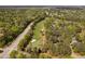 An aerial view of a golf course community reveals stunning green fairways and a beautiful tree-lined neighborhood at 101 Preston Arbor Ln, Cary, NC 27513