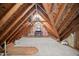 Unfinished attic featuring exposed beams, insulation, carpeting, and ample storage space at 101 Preston Arbor Ln, Cary, NC 27513
